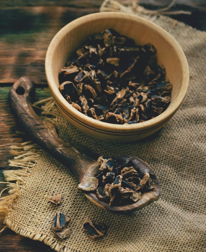 small carob pod pieces in wooden bowl